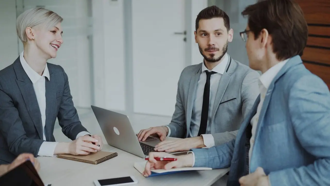 STRP advisors reviewing financials with a client in a modern office
